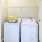 a laundry room with a laundry basket on top of a dryer
