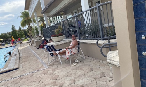 people sitting by a pool