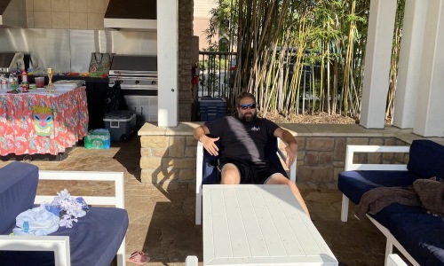 man sitting on lawn furniture