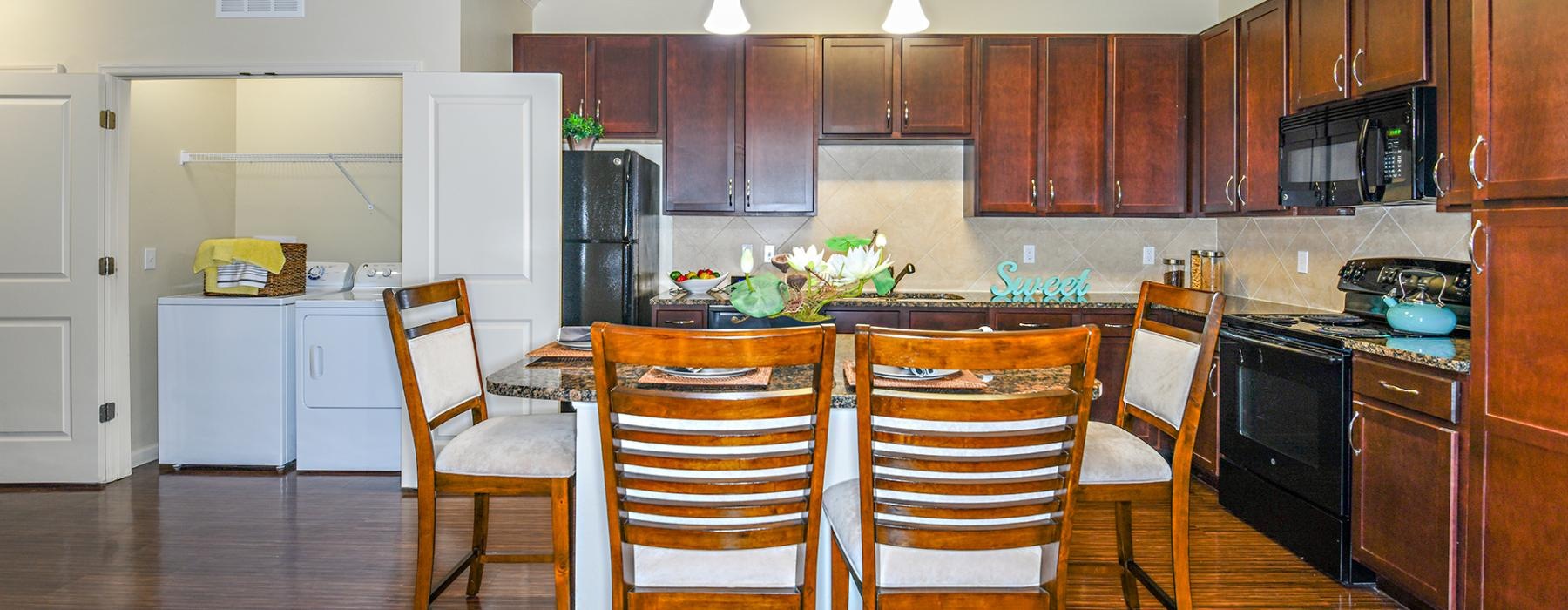 a kitchen with a dining table and chairs