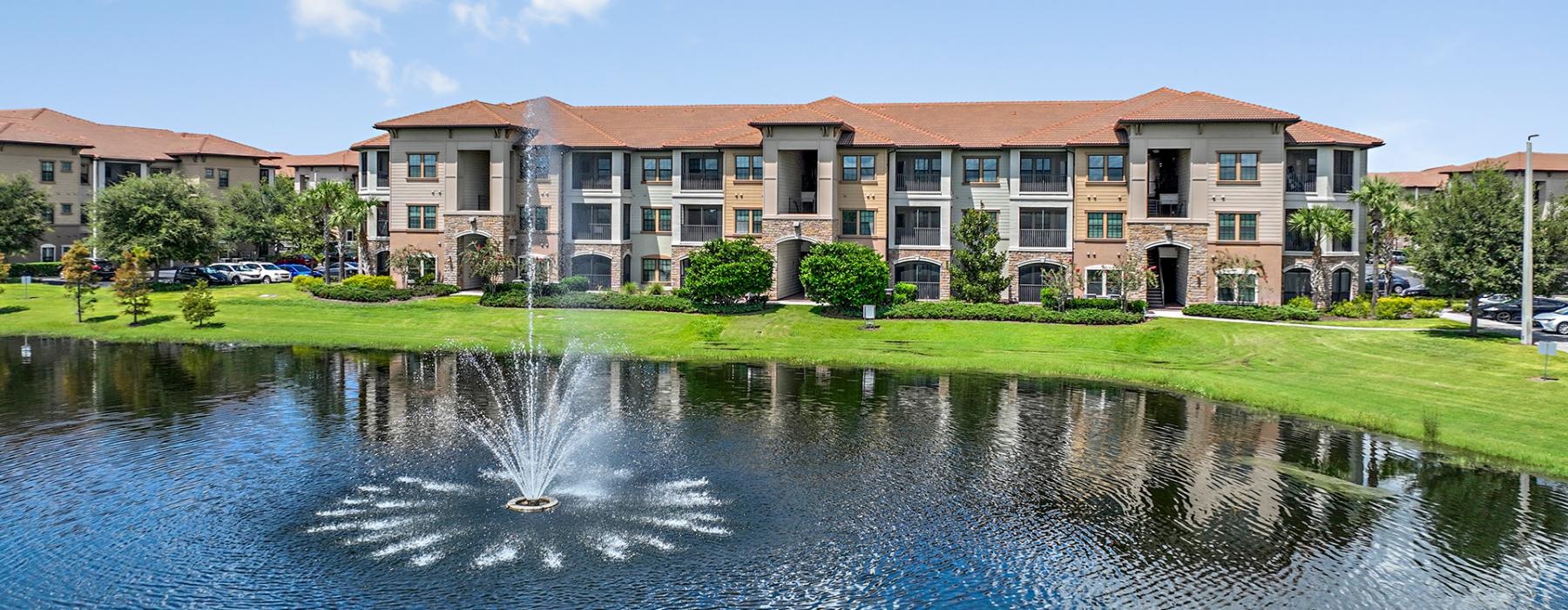 a building with a pond in front of it